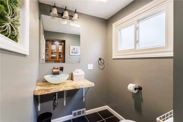 540 List Ave, Irondequoit, NY 14617 - bathroom featuring a sink, tile patterned floors, and baseboards