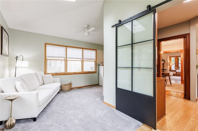 540 List Ave, Irondequoit, NY 14617 - living room with plenty of natural light, ceiling fan, a barn door, and baseboards