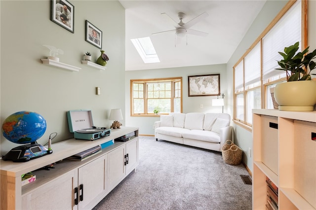 540 List Ave, Irondequoit, NY 14617 - living room with ceiling fan, a skylight, light colored carpet, healthy amount of natural light, and vaulted ceiling