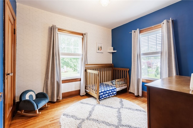 540 List Ave, Irondequoit, NY 14617 - bedroom featuring wood finished floors, baseboards, and a nursery area
