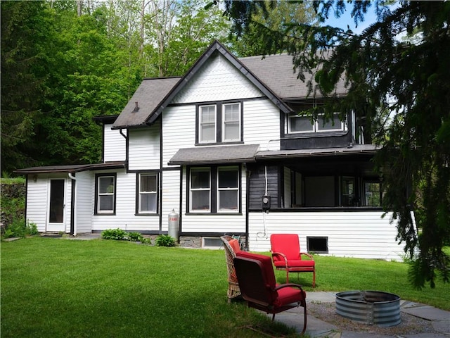 36 Pinetree Ln, Middletown, NY 12430 - rear view of house with an outdoor fire pit, a lawn, and roof with shingles