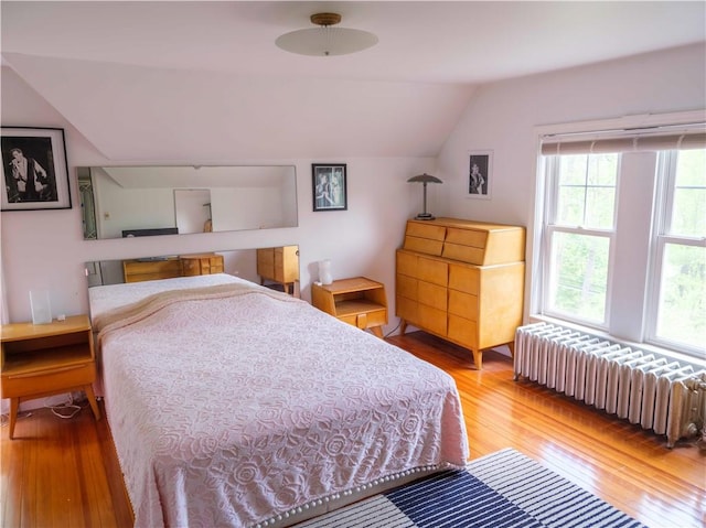 36 Pinetree Ln, Middletown, NY 12430 - bedroom featuring radiator, vaulted ceiling, and wood-type flooring