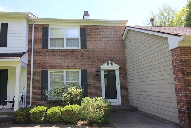 220 New Wickham Dr Unit 220, Penfield, NY 14526 - view of front of property featuring brick siding and a chimney