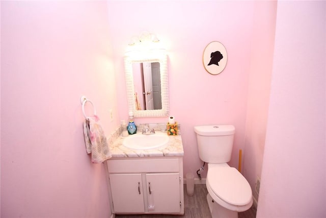 220 New Wickham Dr Unit 220, Penfield, NY 14526 - bathroom with toilet, vanity, and wood finished floors
