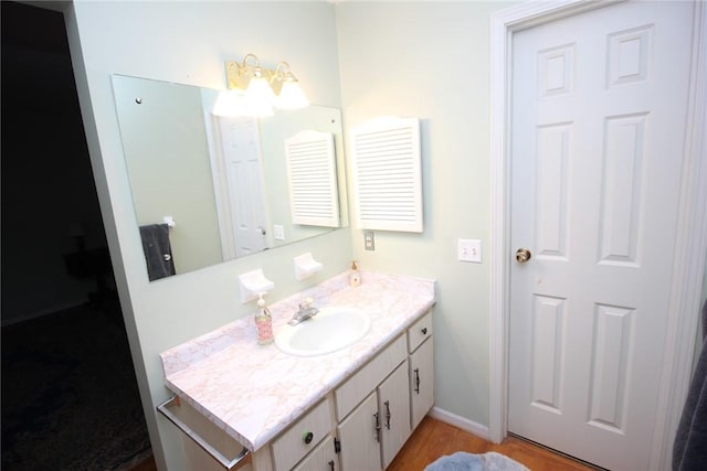 220 New Wickham Dr Unit 220, Penfield, NY 14526 - bathroom featuring vanity, wood finished floors, and baseboards