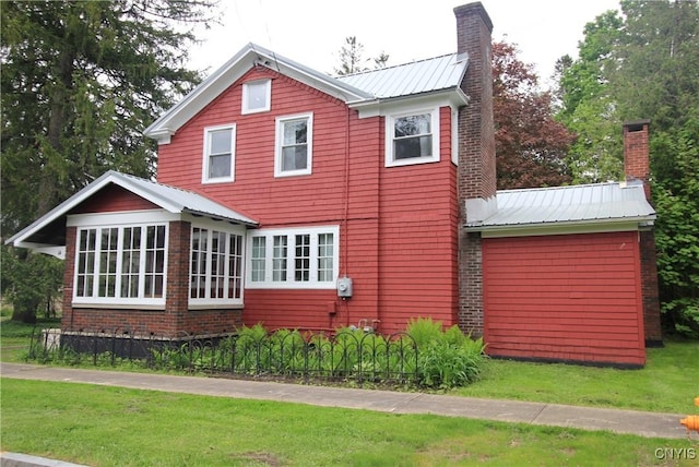 14 Fenner St, Cazenovia, NY 13035 - view of home's exterior with a chimney, metal roof, and a yard