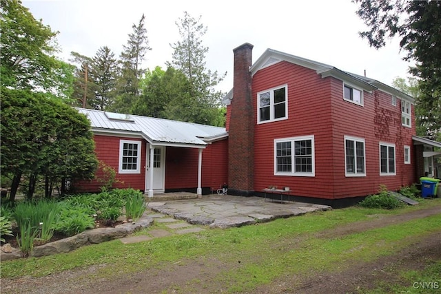 14 Fenner St, Cazenovia, NY 13035 - view of front of house featuring a chimney and a patio