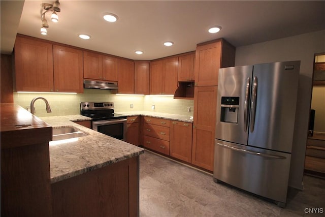 14 Fenner St, Cazenovia, NY 13035 - kitchen with appliances with stainless steel finishes, under cabinet range hood, a sink, brown cabinetry, and recessed lighting