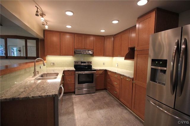 14 Fenner St, Cazenovia, NY 13035 - kitchen with stainless steel appliances, a sink, under cabinet range hood, brown cabinets, and recessed lighting