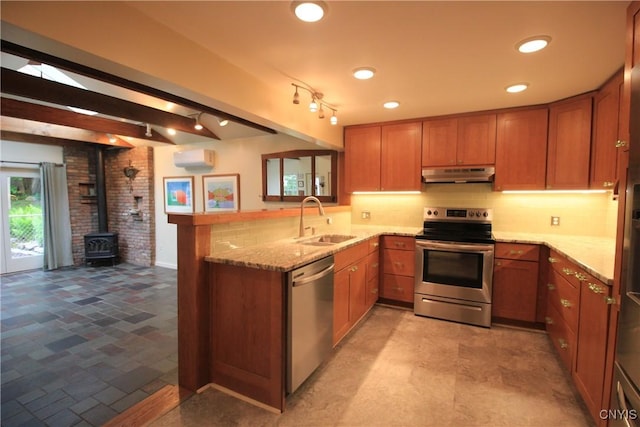 14 Fenner St, Cazenovia, NY 13035 - kitchen featuring appliances with stainless steel finishes, under cabinet range hood, a sink, brown cabinets, and recessed lighting