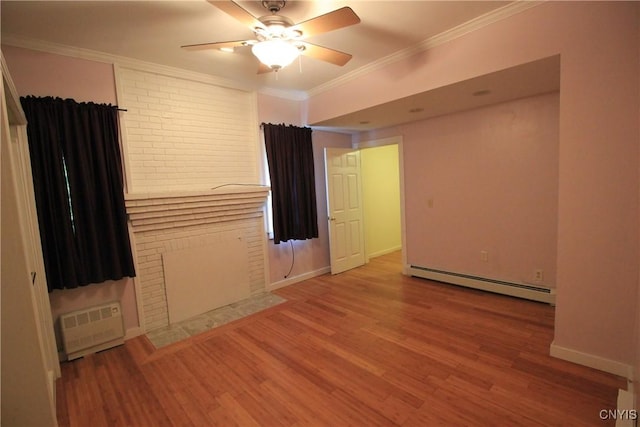 14 Fenner St, Cazenovia, NY 13035 - spare room featuring a baseboard heating unit, wood finished floors, crown molding, a ceiling fan, and baseboards
