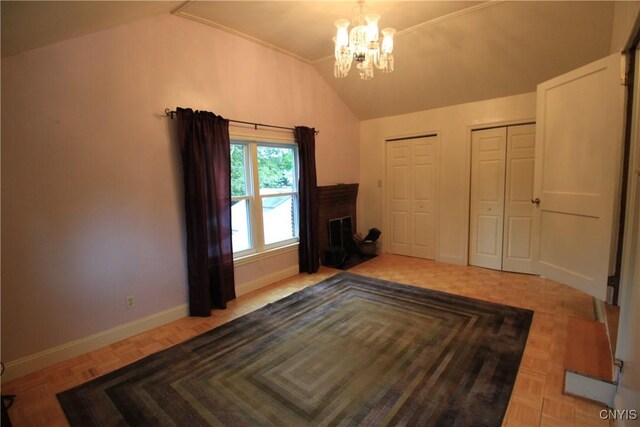 14 Fenner St, Cazenovia, NY 13035 - unfurnished bedroom featuring lofted ceiling, two closets, a chandelier, and baseboards