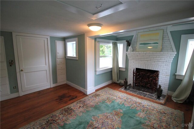 14 Fenner St, Cazenovia, NY 13035 - living room featuring wood finished floors, baseboards, and a brick fireplace