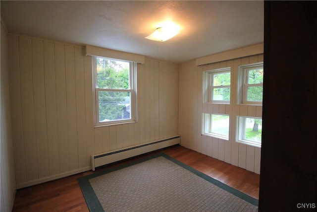 14 Fenner St, Cazenovia, NY 13035 - unfurnished room featuring a baseboard heating unit, wood finished floors, and healthy amount of natural light