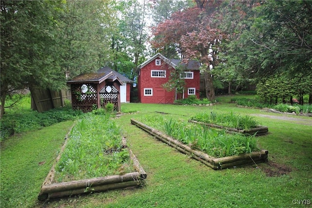 14 Fenner St, Cazenovia, NY 13035 - view of grassy yard featuring a garden, an outdoor structure, and a detached garage