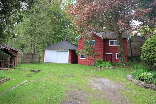 14 Fenner St, Cazenovia, NY 13035 - view of yard featuring a detached garage, an outbuilding, and dirt driveway