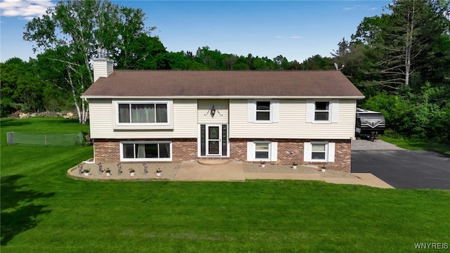 591 Girdle Rd, Elma, NY 14052 - view of front of house with brick siding, a chimney, a front lawn, and a patio area