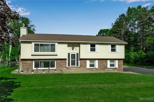 591 Girdle Rd, Elma, NY 14052 - raised ranch featuring a chimney, a front lawn, and brick siding