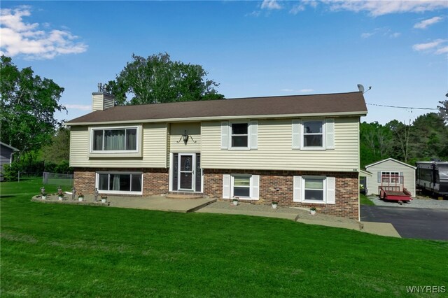 591 Girdle Rd, Elma, NY 14052 - bi-level home featuring a chimney, brick siding, and a front yard