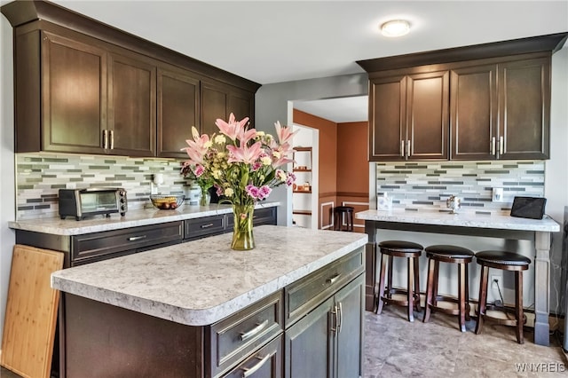 591 Girdle Rd, Elma, NY 14052 - kitchen with light countertops, decorative backsplash, and dark brown cabinetry
