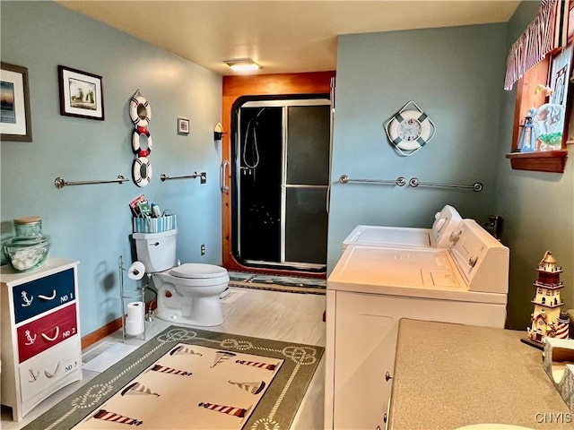 9A Lina St, Morristown, NY 13669 - bathroom with separate washer and dryer, a shower stall, toilet, vanity, and wood finished floors