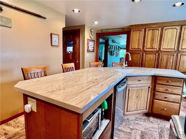 9A Lina St, Morristown, NY 13669 - kitchen with a sink, stainless steel dishwasher, a kitchen island with sink, brown cabinets, and recessed lighting