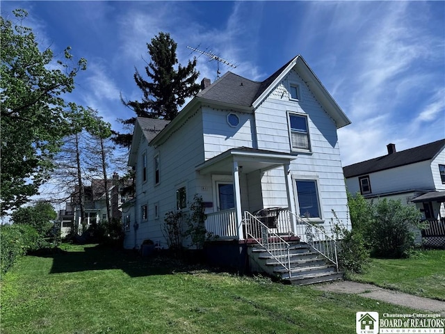 83 E Doughty St, Dunkirk-City, NY 14048 - victorian-style house featuring a front lawn and a chimney