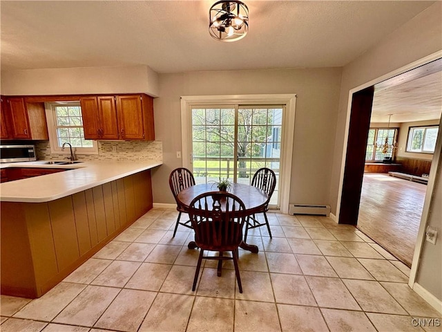 25 Highmore Dr, Oswego-Town, NY 13126 - dining room featuring baseboard heating, light tile patterned floors, and baseboards