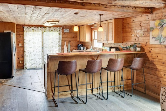2165 Hamden Hill Rd, Hamden, NY 13782 - kitchen with stainless steel fridge, wood ceiling, wooden walls, a peninsula, and light wood finished floors