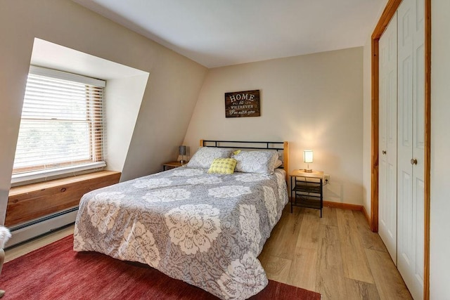 2165 Hamden Hill Rd, Hamden, NY 13782 - bedroom featuring baseboard heating, light wood-style flooring, and a closet