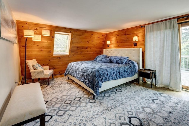 2165 Hamden Hill Rd, Hamden, NY 13782 - bedroom with wooden walls, multiple windows, and wood finished floors