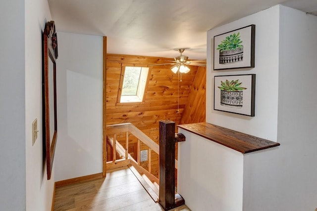 2165 Hamden Hill Rd, Hamden, NY 13782 - hall with wood walls, an upstairs landing, light wood-style floors, and a skylight