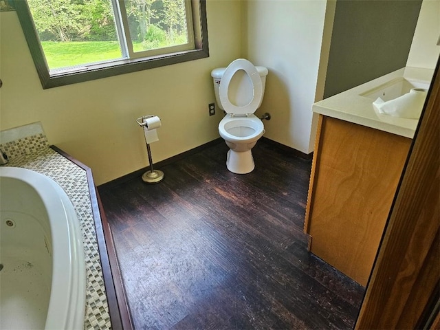 4636 Kirkwood Rd, Cohocton, NY 14826 - bathroom with toilet, wood finished floors, vanity, baseboards, and a jetted tub