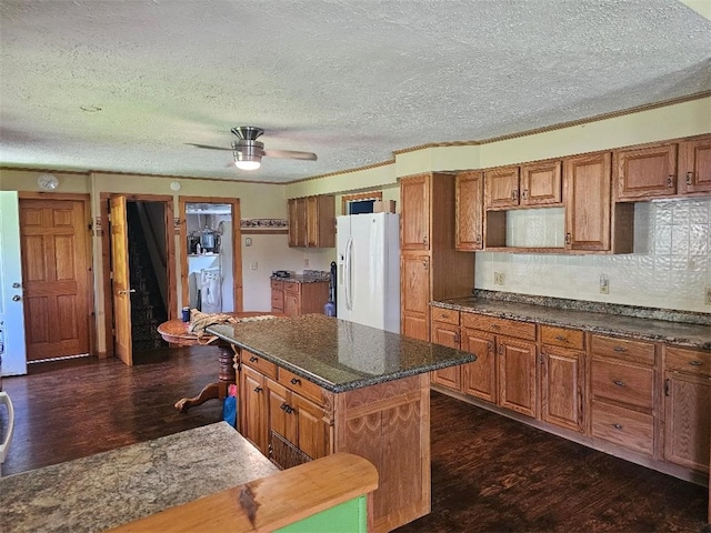 4636 Kirkwood Rd, Cohocton, NY 14826 - kitchen with white refrigerator with ice dispenser, dark wood-style floors, brown cabinetry, and a textured ceiling