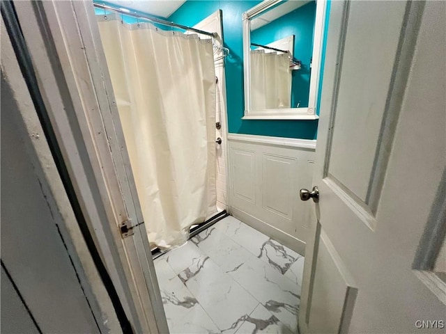1703 Whitesboro St, Utica, NY 13502 - bathroom with marble finish flooring, curtained shower, and wainscoting
