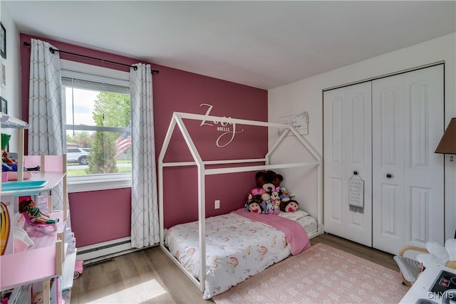 436 Centre St, Cape Vincent, NY 13618 - bedroom featuring wood finished floors, a baseboard heating unit, and a closet