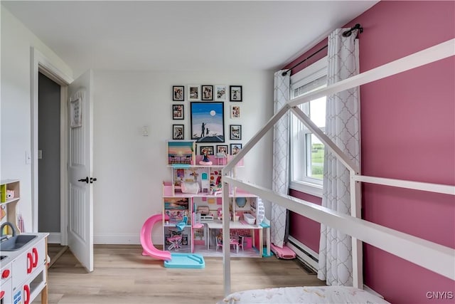 436 Centre St, Cape Vincent, NY 13618 - rec room featuring wood finished floors, a baseboard radiator, and baseboards