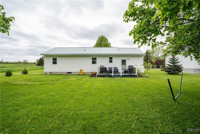 436 Centre St, Cape Vincent, NY 13618 - rear view of property featuring a wooden deck, a lawn, and metal roof