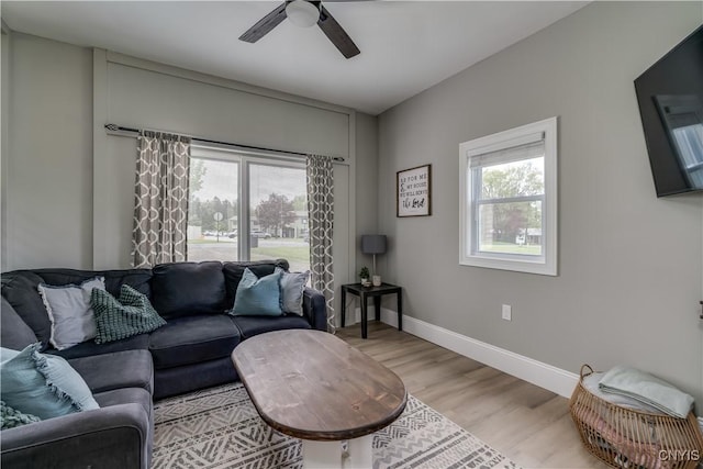 436 Centre St, Cape Vincent, NY 13618 - living room with healthy amount of natural light, a ceiling fan, light wood finished floors, and baseboards
