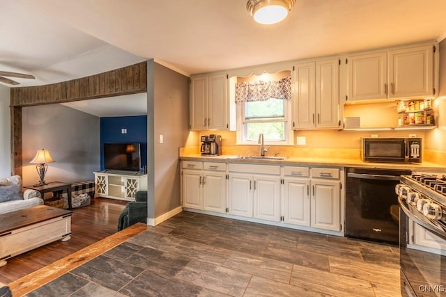 906 Beley Ave, Salina, NY 13211 - kitchen with a sink, black appliances, light countertops, white cabinetry, and baseboards