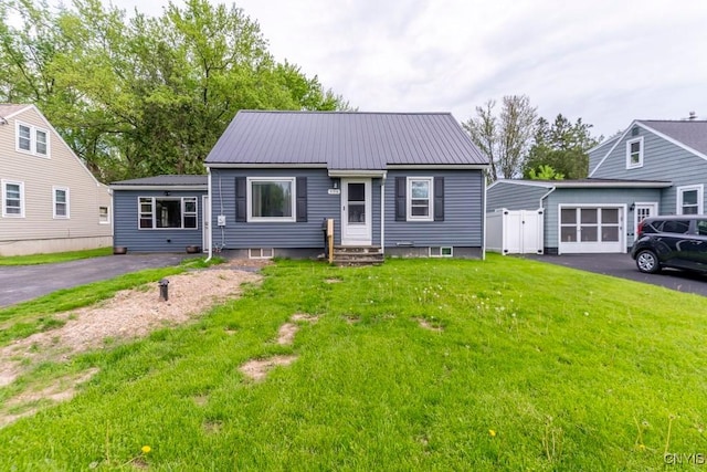 906 Beley Ave, Salina, NY 13211 - view of front of property featuring driveway, a front yard, metal roof, an attached garage, and entry steps