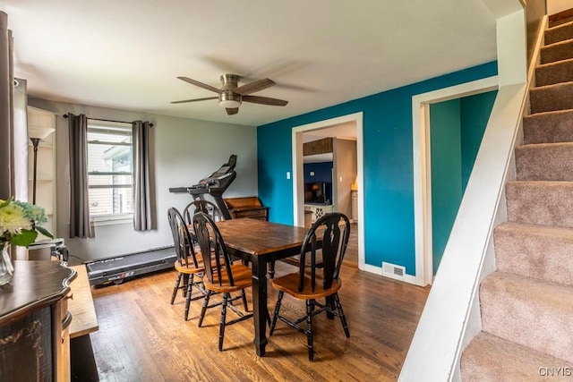 906 Beley Ave, Salina, NY 13211 - dining room featuring stairs, ceiling fan, wood finished floors, and a baseboard heating unit