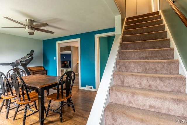 906 Beley Ave, Salina, NY 13211 - dining space with wood finished floors, a ceiling fan, and stairway