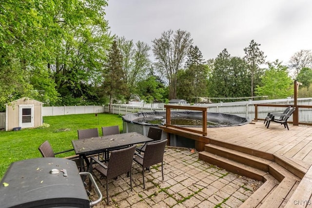 906 Beley Ave, Salina, NY 13211 - wooden deck featuring outdoor dining space, view of wooded area, area for grilling, and a patio