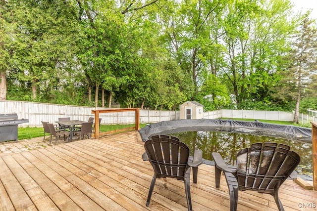 906 Beley Ave, Salina, NY 13211 - wooden terrace featuring a fenced backyard, outdoor dining area, view of scattered trees, and a grill