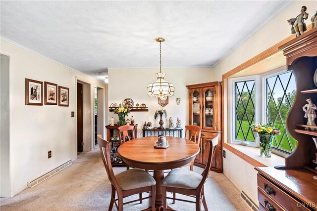 829 Franklin St, Skaneateles, NY 13152 - dining area with light colored carpet, a chandelier, crown molding, and baseboards