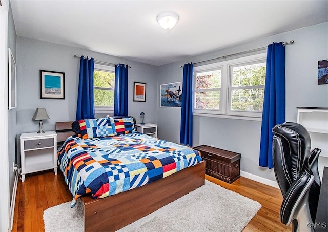 106 Peterson Dr, Camillus, NY 13031 - bedroom with wood finished floors, baseboards, and an office area