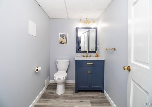 106 Peterson Dr, Camillus, NY 13031 - bathroom with toilet, vanity, a paneled ceiling, wood finished floors, and baseboards