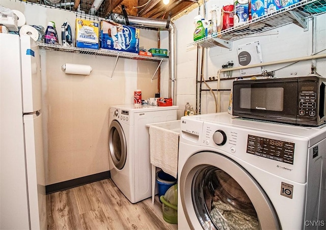 106 Peterson Dr, Camillus, NY 13031 - laundry area featuring washer and clothes dryer and light wood-type flooring