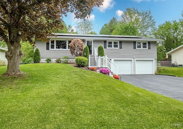 106 Peterson Dr, Camillus, NY 13031 - view of front of house with asphalt driveway, an attached garage, roof mounted solar panels, and a front lawn